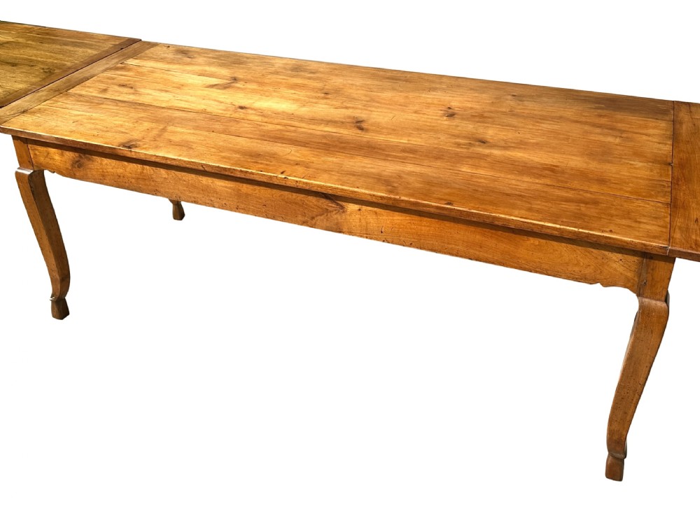 An early 19th-century warm brown extending farmhouse dining table with two end pull-out extensions supported by additional legs. View XI