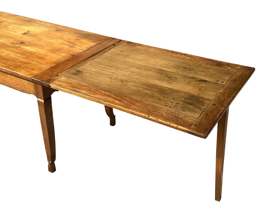 An early 19th-century warm brown extending farmhouse dining table with two end pull-out extensions supported by additional legs. View XII