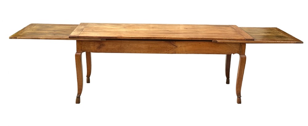 An early 19th-century warm brown extending farmhouse dining table with two end pull-out extensions supported by additional legs. View XIV