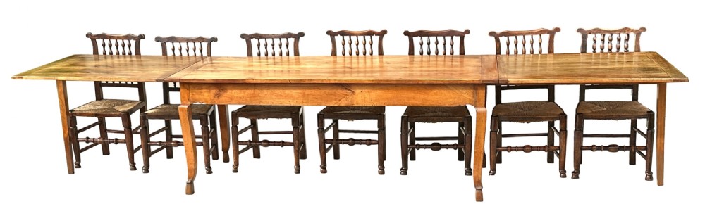 An early 19th-century warm brown extending farmhouse dining table with two end pull-out extensions supported by additional legs. View XXII