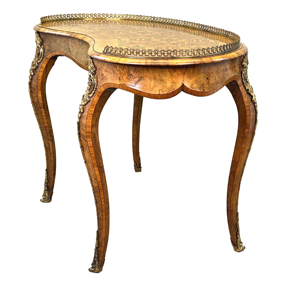 A 19th-century kidney-shaped burr walnut table featuring marquetry inlay, cabriole legs, and brass ormolu mounts with a pierced gallery edge. View VIII