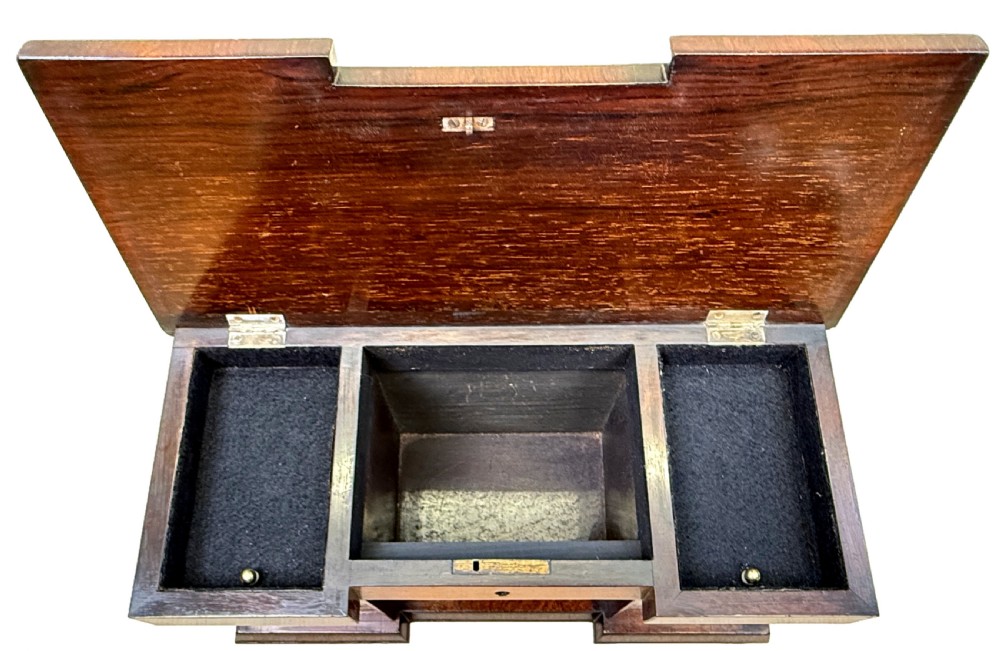 A dark rosewood tea caddy crafted in the shape of a miniature Regency breakfront sideboard with a carved cresting backboard. View VI