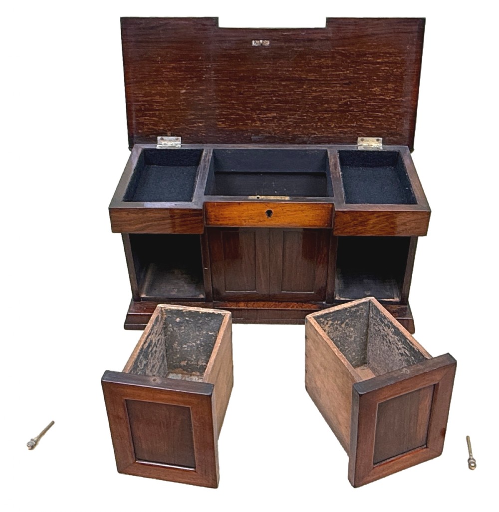 A dark rosewood tea caddy crafted in the shape of a miniature Regency breakfront sideboard with a carved cresting backboard. View VII