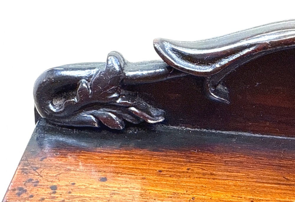 A dark rosewood tea caddy crafted in the shape of a miniature Regency breakfront sideboard with a carved cresting backboard. View VIII