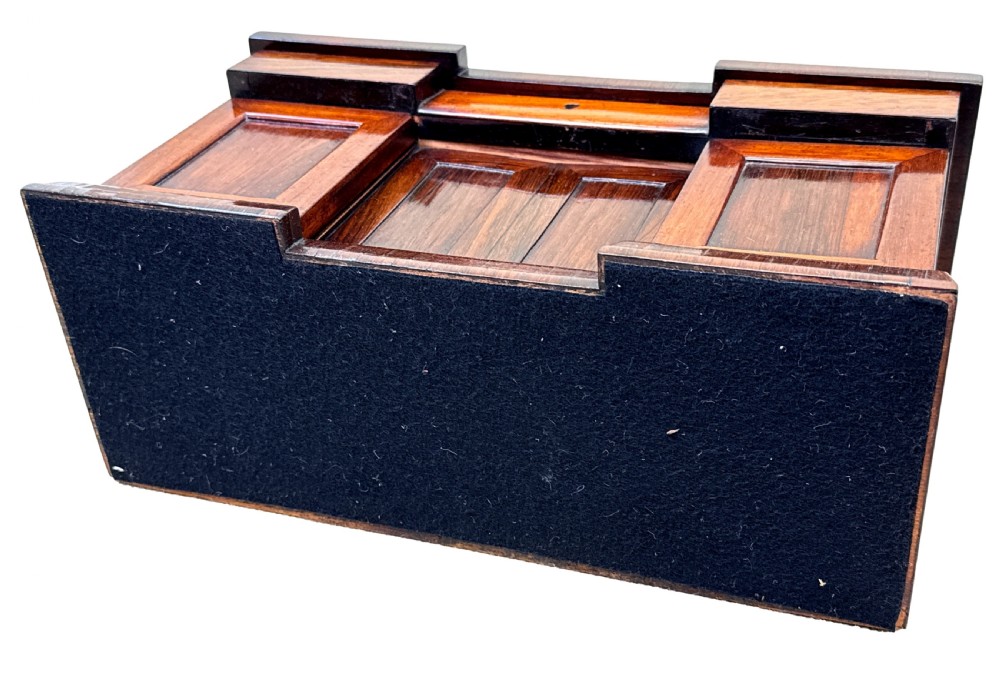 A dark rosewood tea caddy crafted in the shape of a miniature Regency breakfront sideboard with a carved cresting backboard. View IX