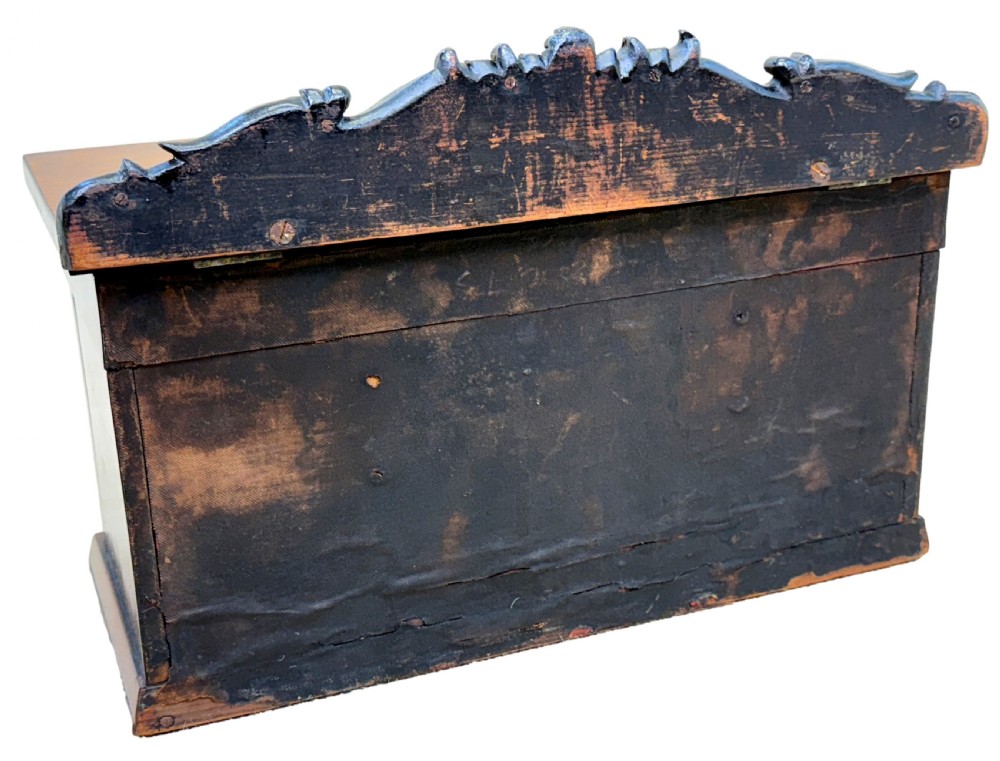 A dark rosewood tea caddy crafted in the shape of a miniature Regency breakfront sideboard with a carved cresting backboard. View X