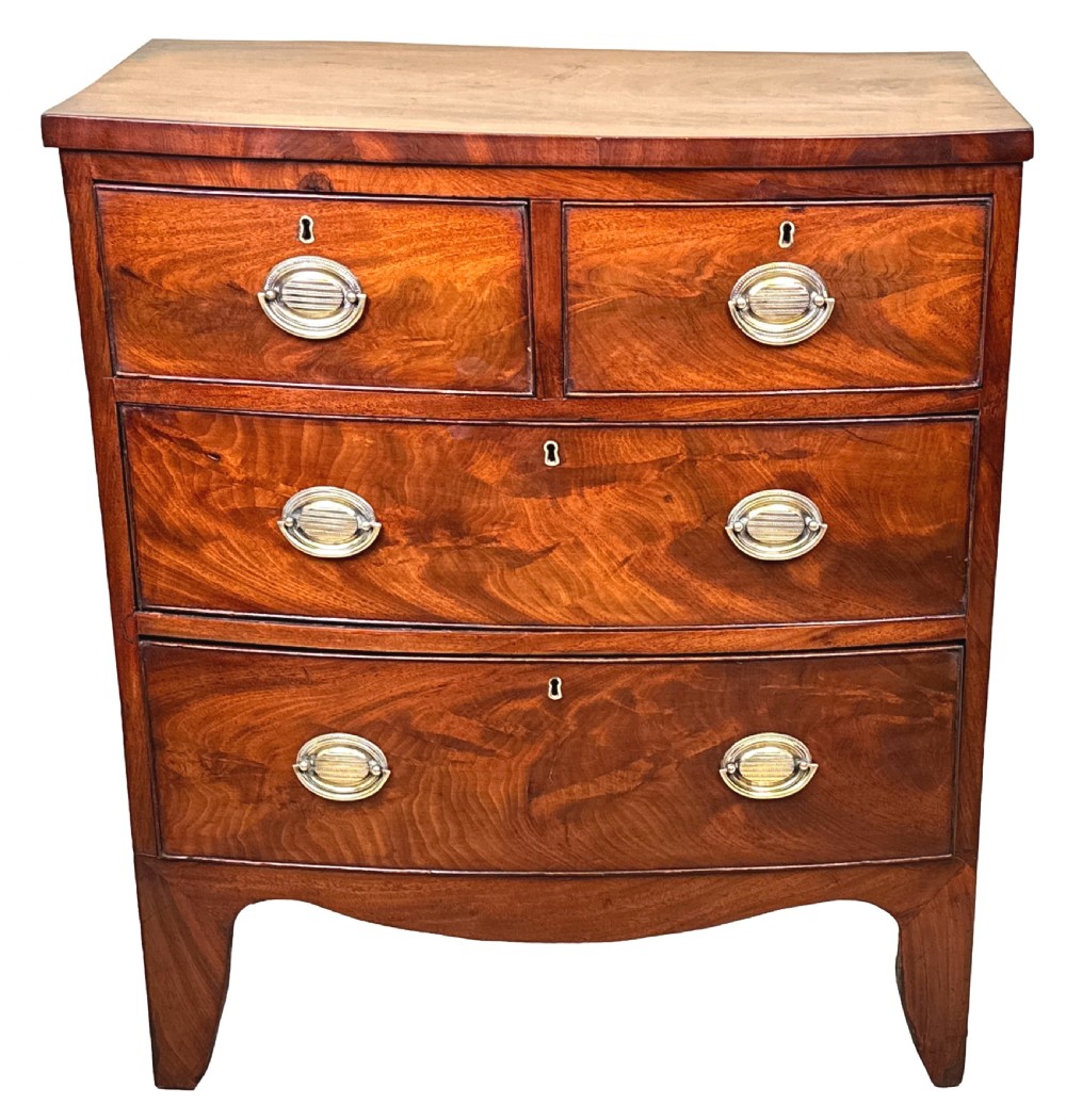 A Victorian miniature mahogany bowfront chest featuring two short over two long drawers with turned wooden knobs and bracket feet. View II