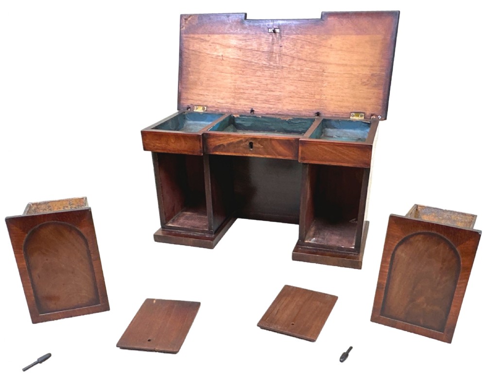 A miniature Regency mahogany tea caddy crafted in the form of a pedestal sideboard with a fan-carved cresting backrail. View VI
