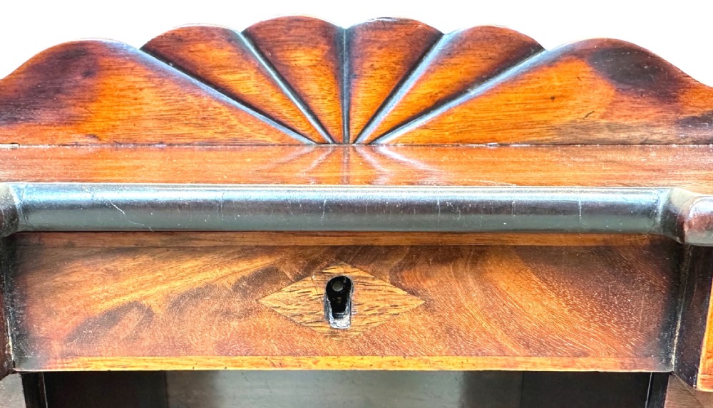 A miniature Regency mahogany tea caddy crafted in the form of a pedestal sideboard with a fan-carved cresting backrail. View VIII