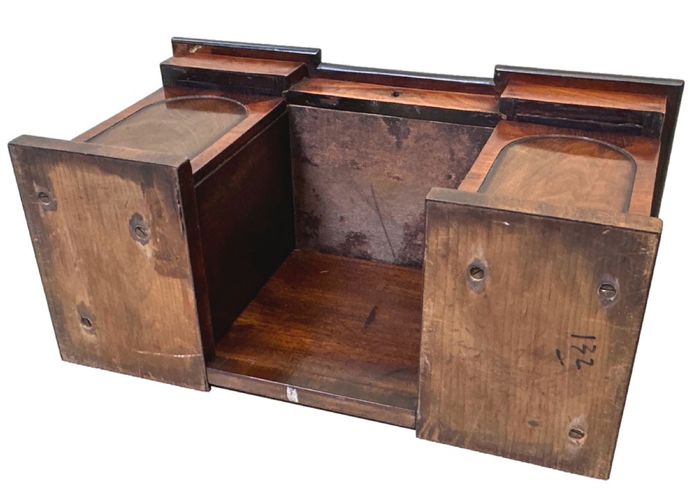 A miniature Regency mahogany tea caddy crafted in the form of a pedestal sideboard with a fan-carved cresting backrail. View X