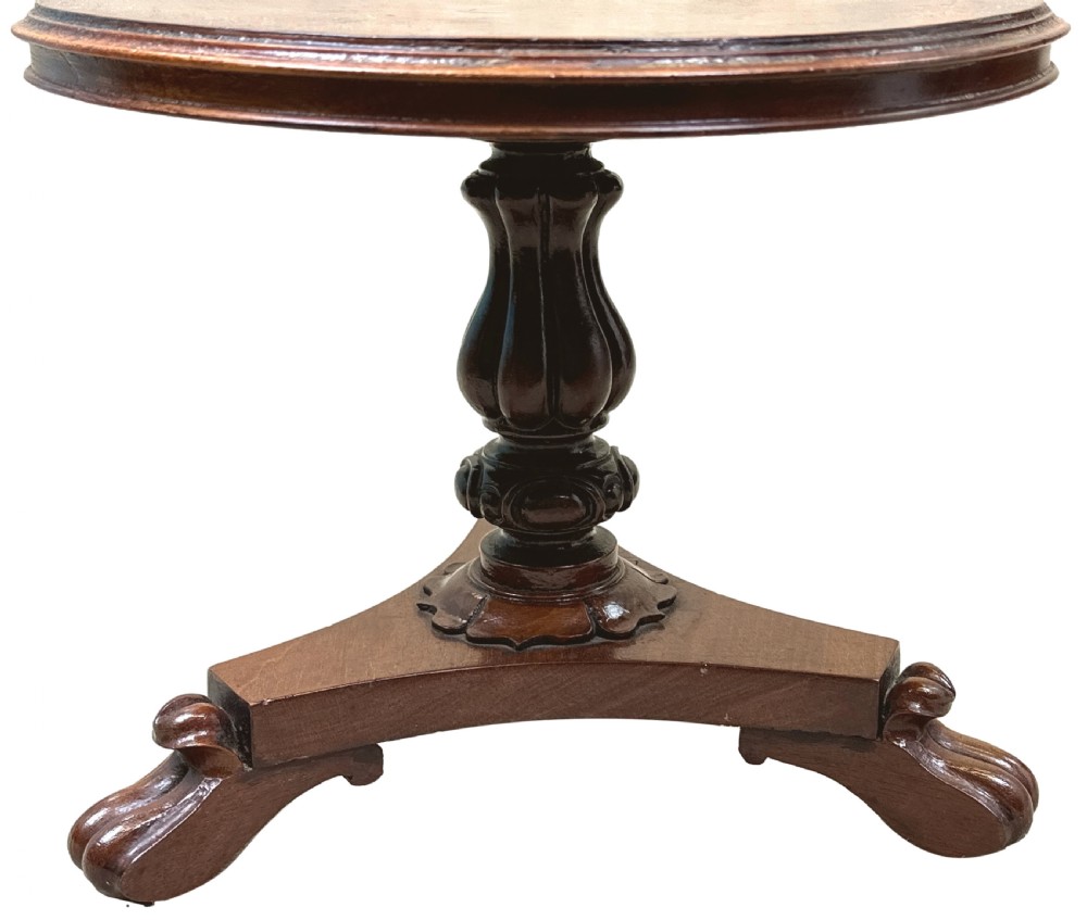 A mid-19th-century miniature circular mahogany centre table featuring a turned central column and a triform base with carved feet. View VIII