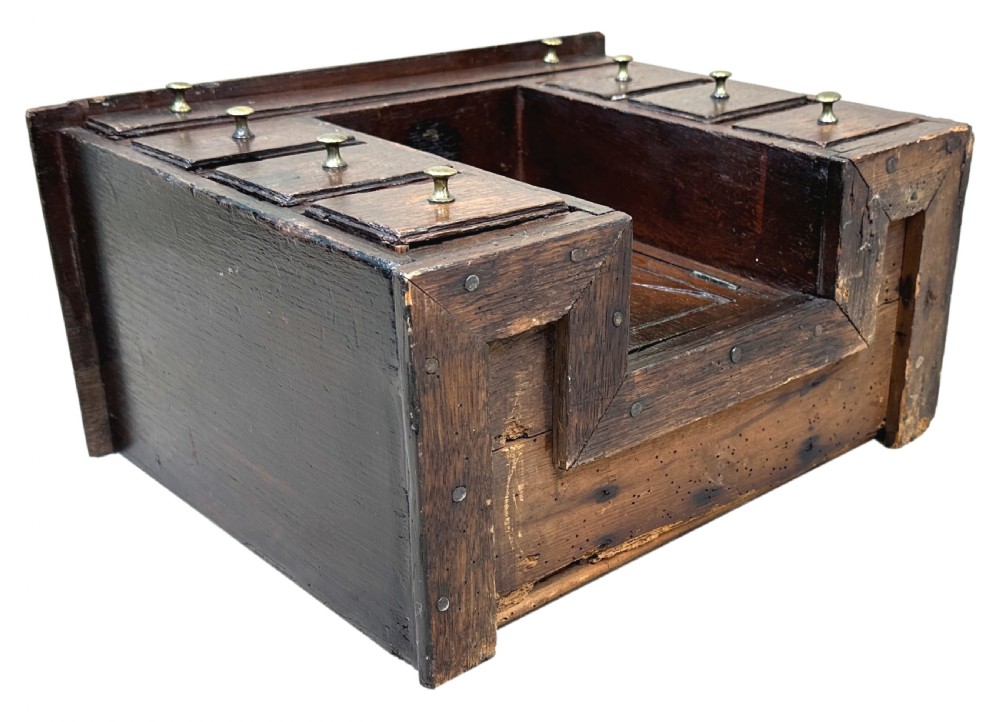 A dark oak miniature kneehole desk featuring a single top drawer over six side drawers and a central cupboard with a key and brass knobs. View IX