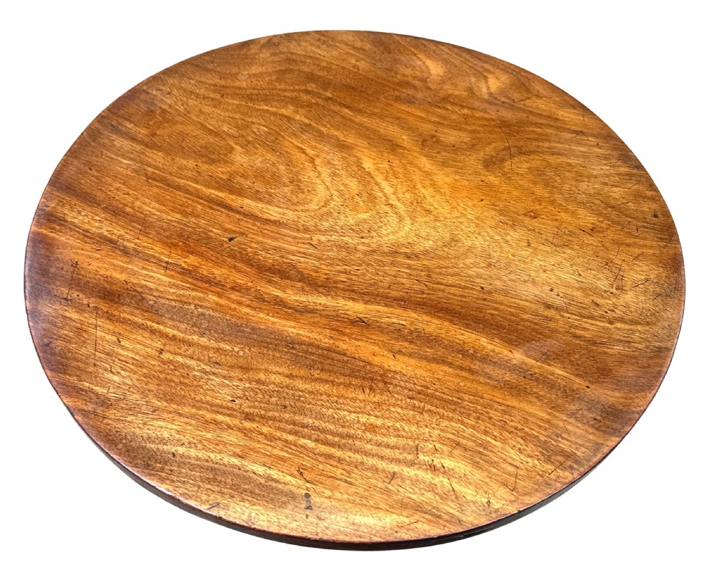 A Regency style miniature mahogany breakfast table with a circular tilt top, a central turned pedestal, and four splayed legs fitted with brass castors. View III