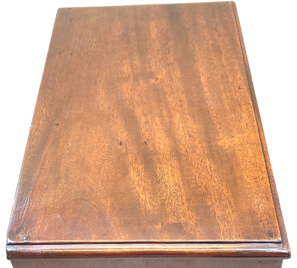 A small Georgian mahogany miniature chest featuring three drawers with brass knob handles, diamond-shaped escutcheons, and a shaped apron. View III