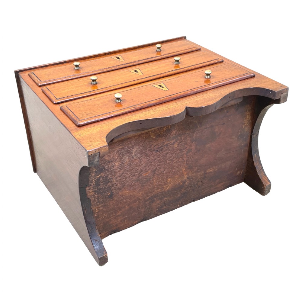 A small Georgian mahogany miniature chest featuring three drawers with brass knob handles, diamond-shaped escutcheons, and a shaped apron. View VIII