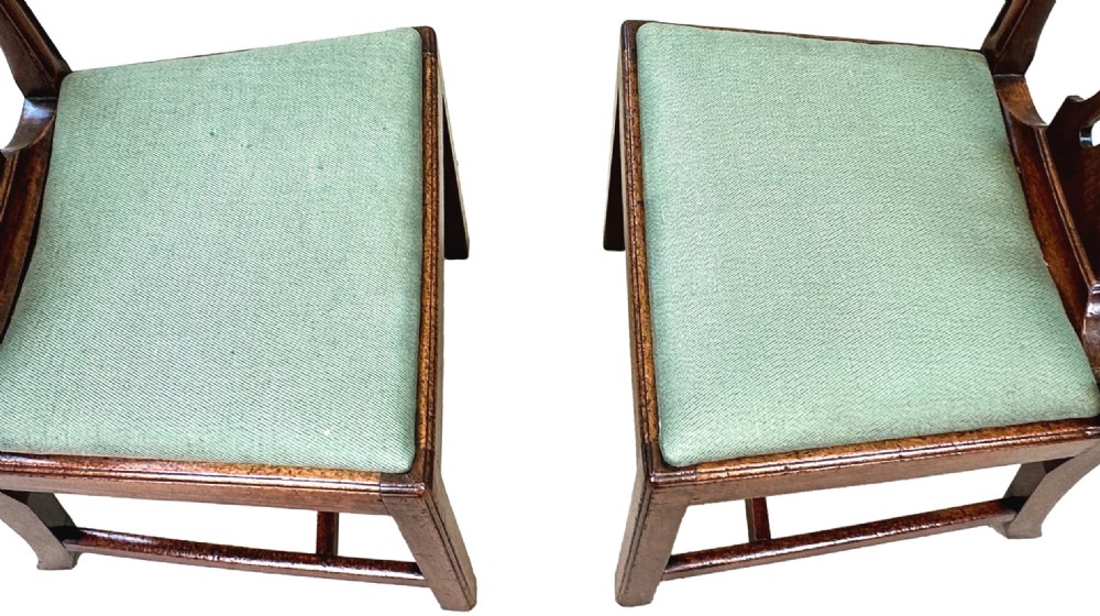 A pair of 18th-century Georgian mahogany side chairs featuring pierced back splats, serpentine top rails, and light green upholstered drop-in seats. View VIII