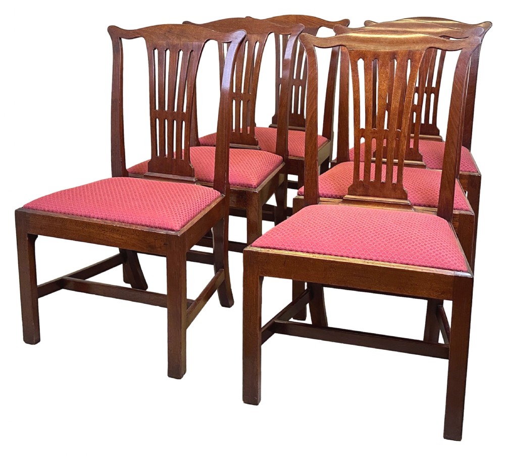 A set of six Chippendale period mahogany dining chairs with vertical slat splat backs, straight legs, and red textured upholstered seats. View V