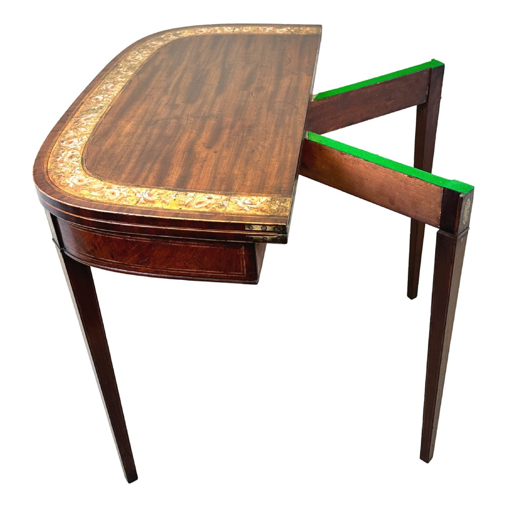 An eighteenth-century Georgian demilune mahogany tea table featuring decorative marquetry border, central brass mount, and tapered legs. View IX