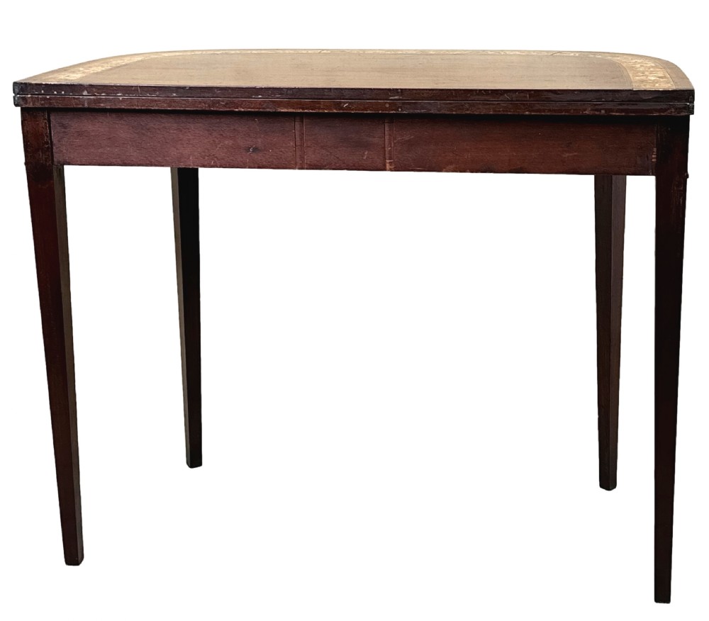 An eighteenth-century Georgian demilune mahogany tea table featuring decorative marquetry border, central brass mount, and tapered legs. View XIV