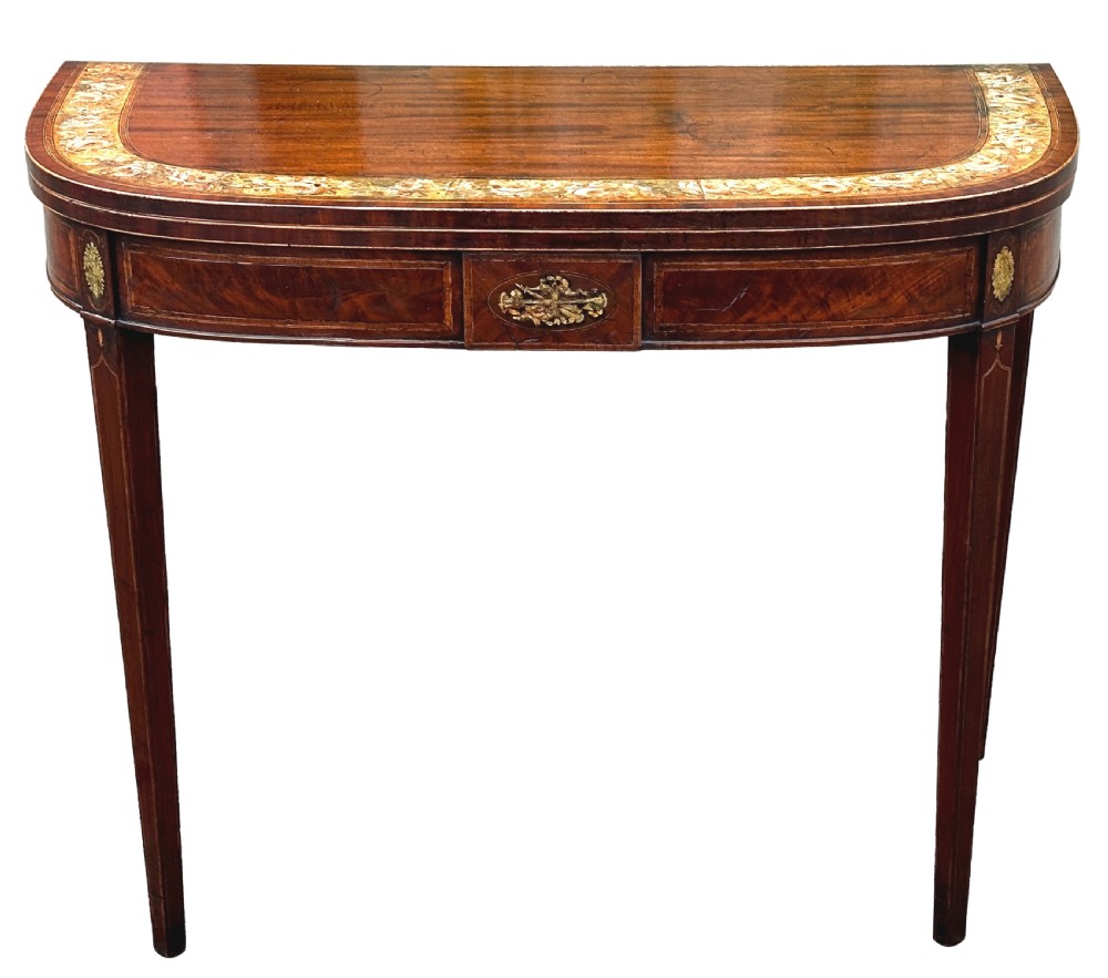 An eighteenth-century Georgian demilune mahogany tea table featuring decorative marquetry border, central brass mount, and tapered legs. View XV
