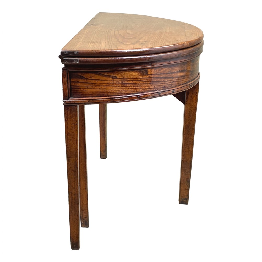 A Georgian elm demi-lune tea table displaying rich wood grain, a fold-over top, and square tapered legs. View II