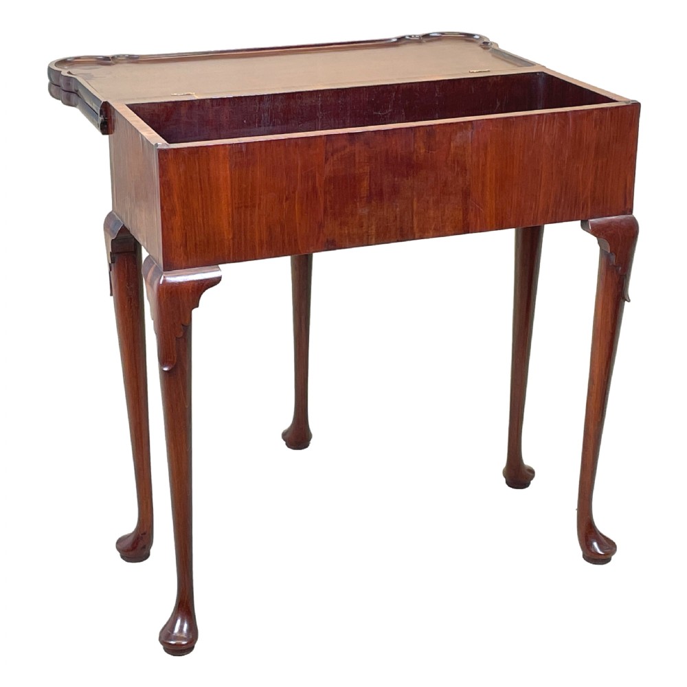 An 18th-century walnut tea table featuring a fold-over rectangular top with shaped corners, elevated on slender cabriole legs with pad feet. View II