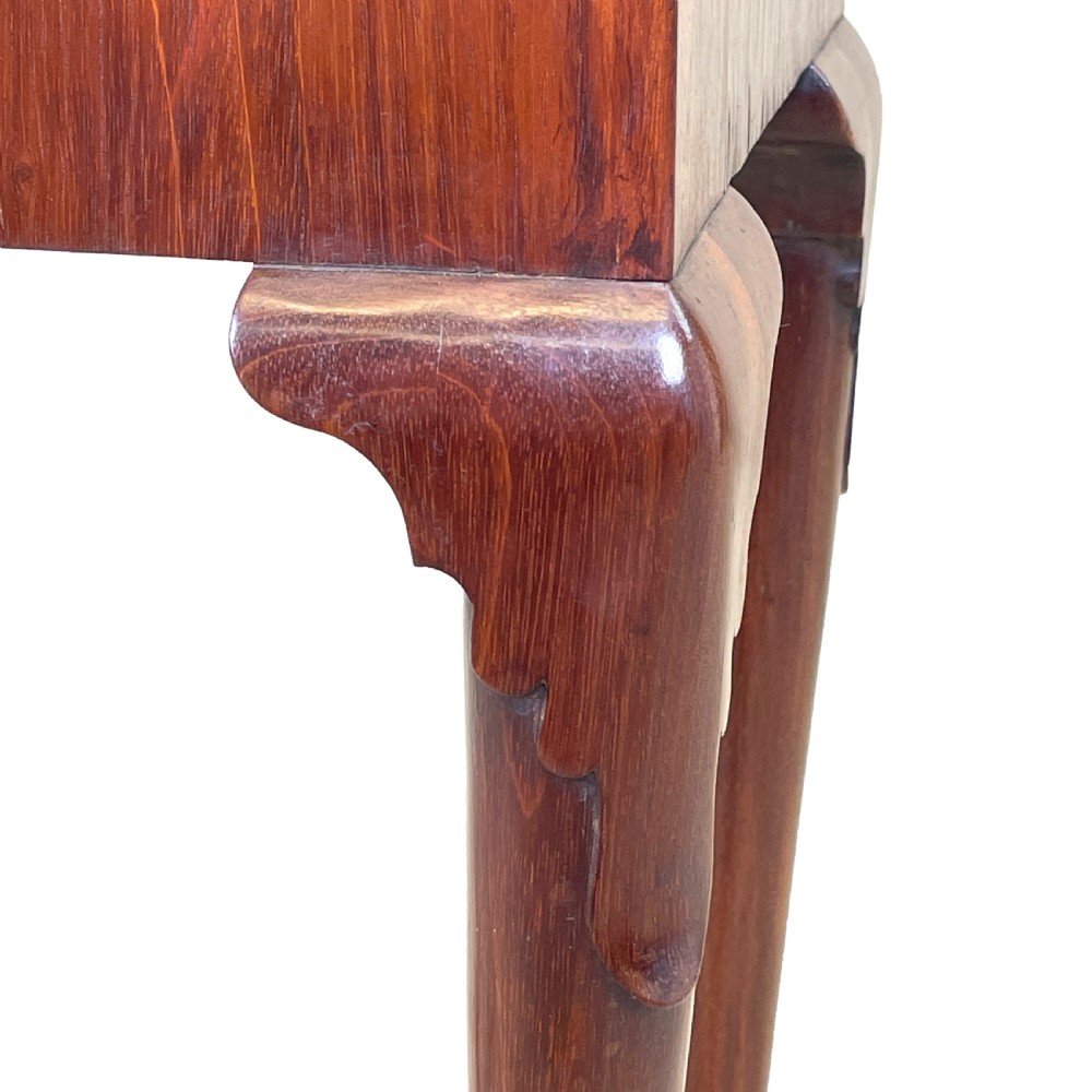 An 18th-century walnut tea table featuring a fold-over rectangular top with shaped corners, elevated on slender cabriole legs with pad feet. View IV