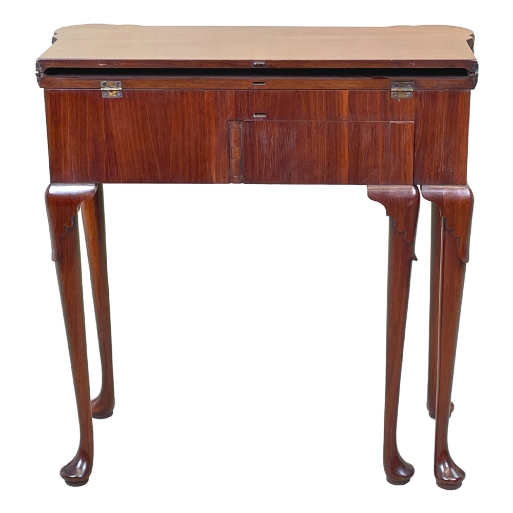 An 18th-century walnut tea table featuring a fold-over rectangular top with shaped corners, elevated on slender cabriole legs with pad feet. View XII