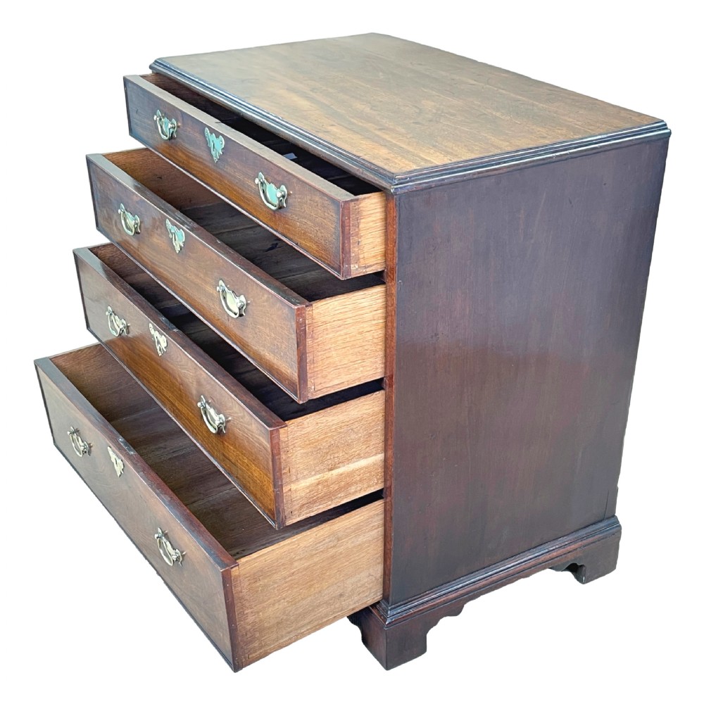An 18th-century Georgian mahogany chest of drawers featuring four graduated drawers with brass swan-neck handles, escutcheons, and bracket feet. View III
