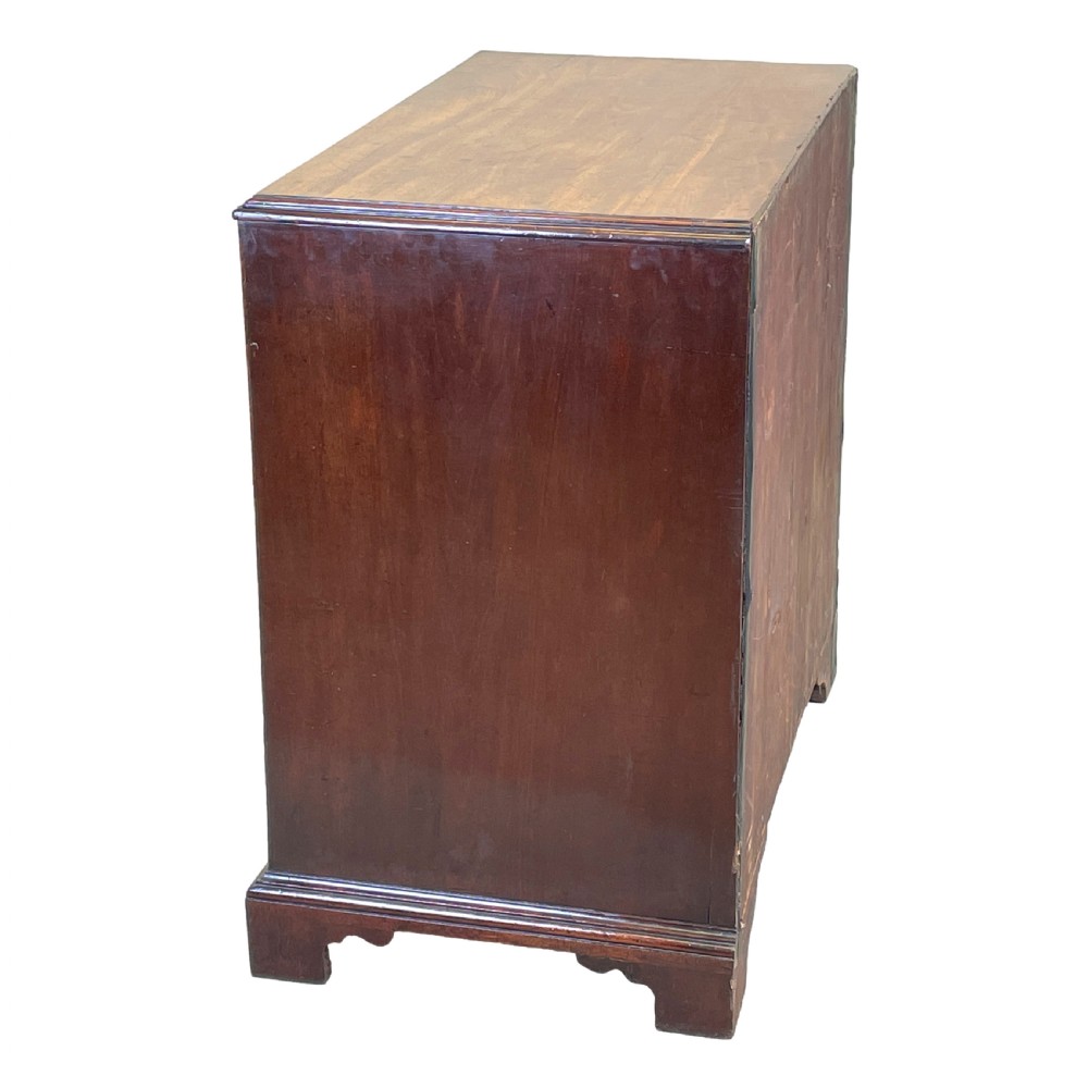 An 18th-century Georgian mahogany chest of drawers featuring four graduated drawers with brass swan-neck handles, escutcheons, and bracket feet. View VI