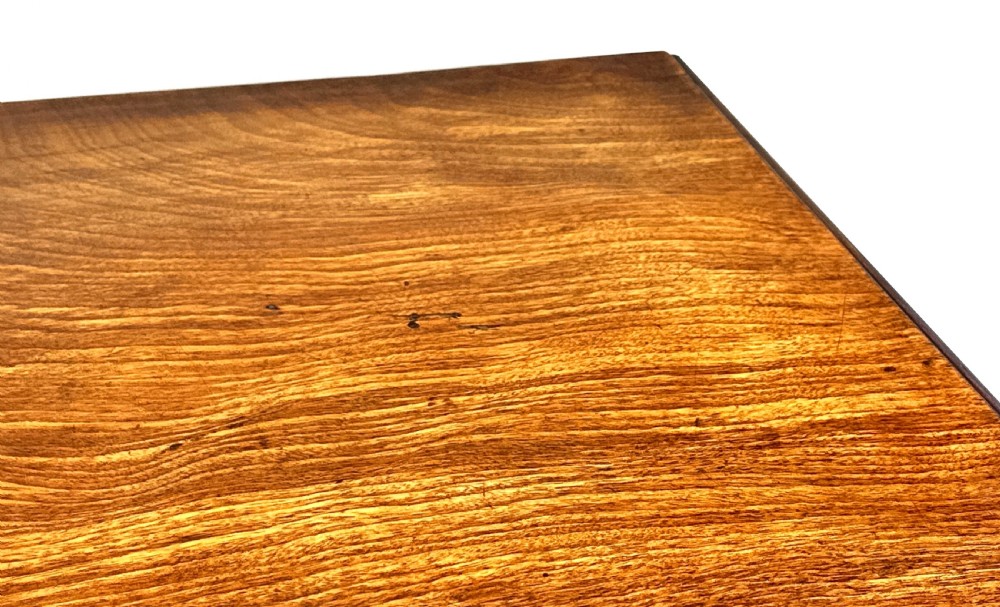 A Georgian mahogany kneehole desk featuring a long top drawer, two side banks of three drawers, a central recessed cupboard, and decorative brass handles. View VII