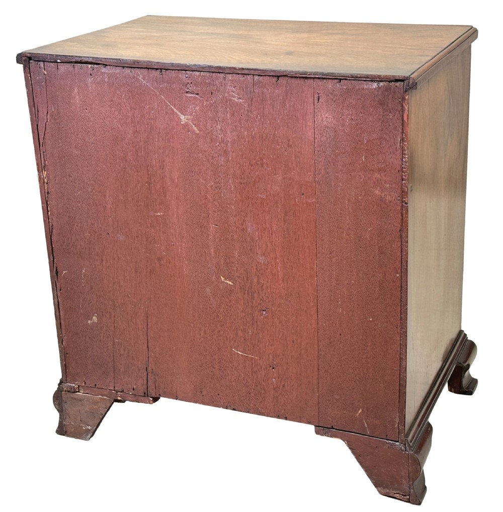 A Georgian mahogany kneehole desk featuring a long top drawer, two side banks of three drawers, a central recessed cupboard, and decorative brass handles. View X