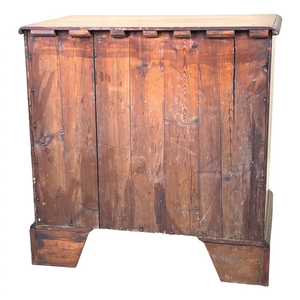 An 18th-century walnut chest of drawers featuring four graduated drawers with ornamental brass handles and escutcheons resting on shaped bracket feet. View IX