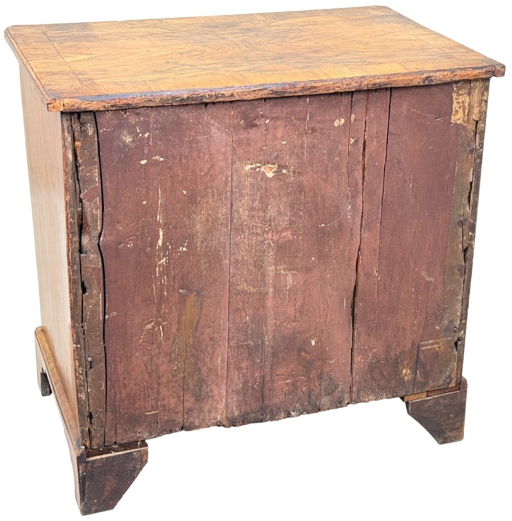 An 18th-century Georgian walnut kneehole desk featuring figured veneer drawer fronts, brass drop handles, and bracket feet. View XV