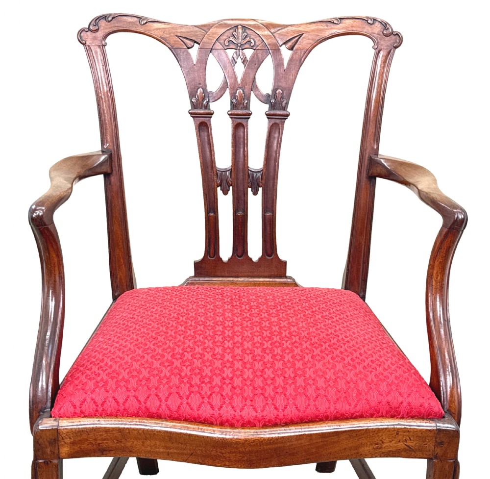 An 18th-century Chippendale style mahogany open armchair with a carved pierced back splat, curved arms, and red woven seat upholstery. View II