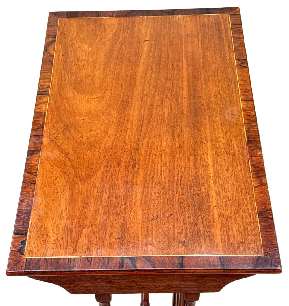 A set of four graduating 19th-century mahogany quartetto nesting tables featuring slender turned legs and trestle bases. View II