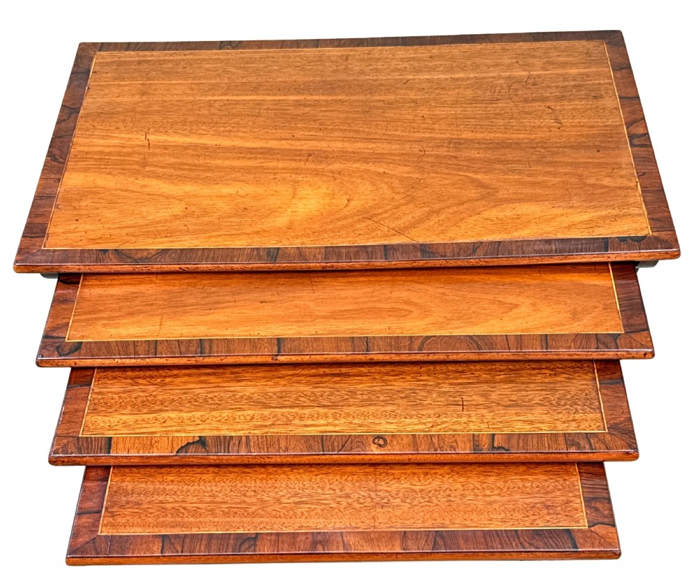 A set of four graduating 19th-century mahogany quartetto nesting tables featuring slender turned legs and trestle bases. View IV