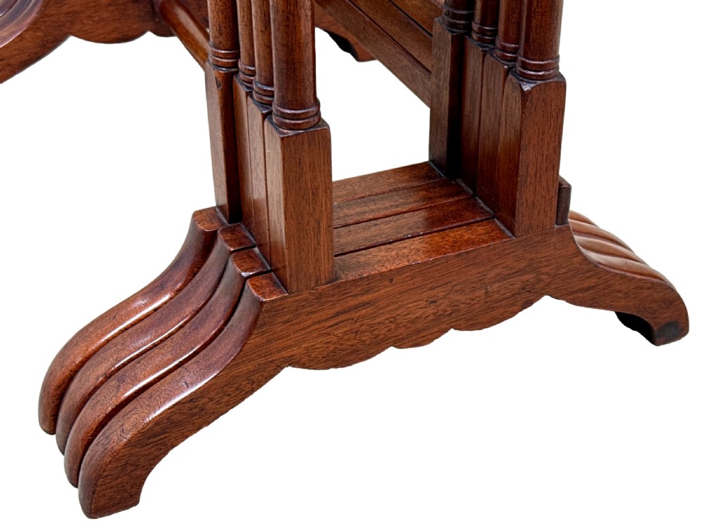A set of four graduating 19th-century mahogany quartetto nesting tables featuring slender turned legs and trestle bases. View V
