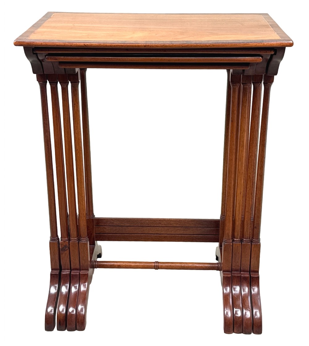 A set of four graduating 19th-century mahogany quartetto nesting tables featuring slender turned legs and trestle bases. View VII
