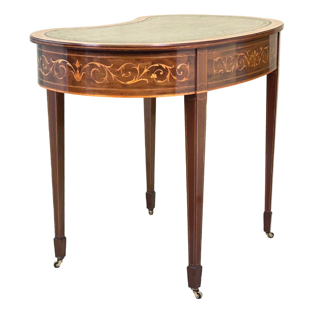 A nineteenth-century mahogany kidney-shaped writing table featuring foliate marquetry, a dark leather insert, and square tapered legs with brass castors. View III