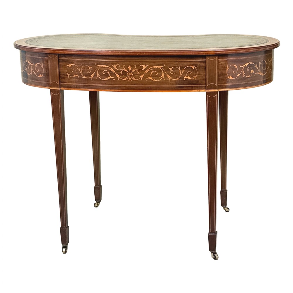 A nineteenth-century mahogany kidney-shaped writing table featuring foliate marquetry, a dark leather insert, and square tapered legs with brass castors. View VII