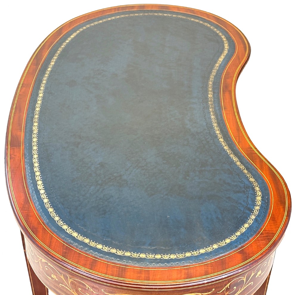 A nineteenth-century mahogany kidney-shaped writing table featuring foliate marquetry, a dark leather insert, and square tapered legs with brass castors. View XI