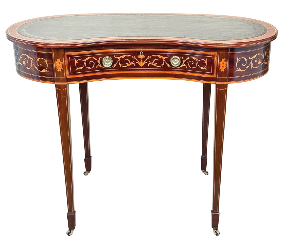A nineteenth-century mahogany kidney-shaped writing table featuring foliate marquetry, a dark leather insert, and square tapered legs with brass castors. View XIV