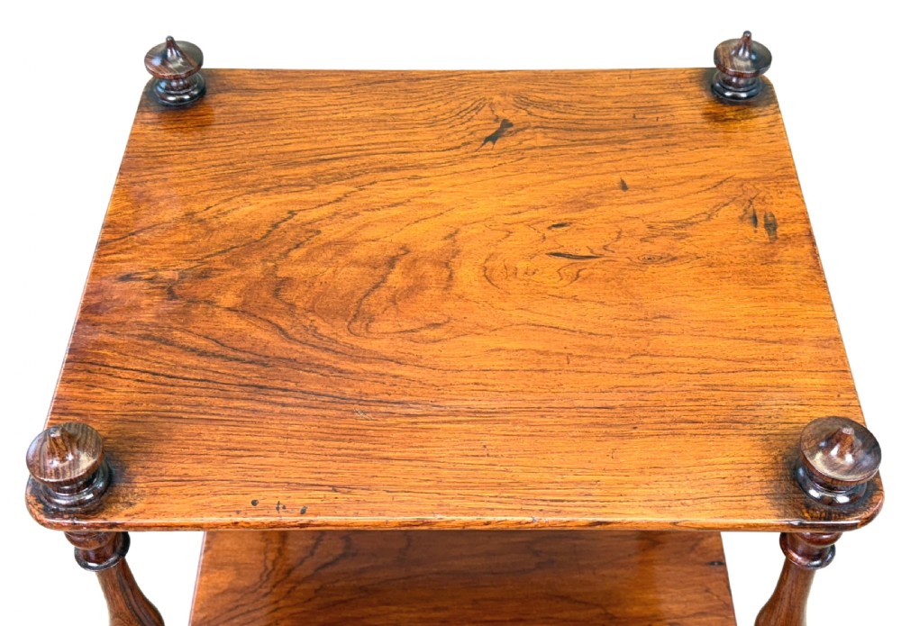 A three-tiered 19th-century rosewood whatnot featuring slender turned spindles, top finials, and legs ending in brass castors. View II