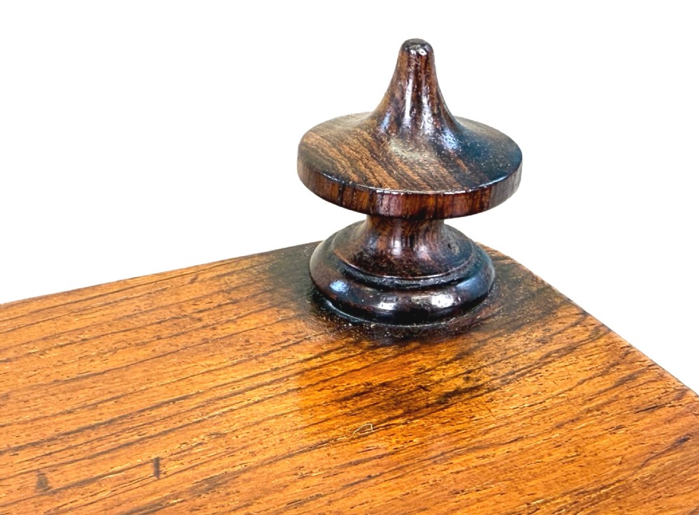 A three-tiered 19th-century rosewood whatnot featuring slender turned spindles, top finials, and legs ending in brass castors. View IX