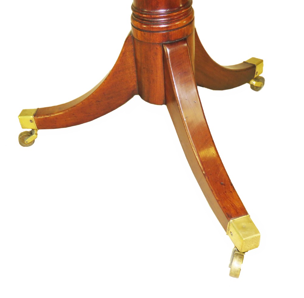 A late eighteenth-century mahogany dumbwaiter featuring two circular folding tiers supported by a central turned column and tripod legs with brass castors. View III