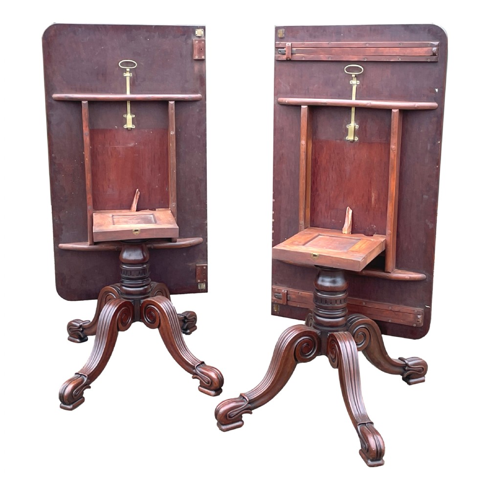 A Regency mahogany twin pillar dining table with an extending centre leaf and carved pedestal supports on brass castors. View VIII