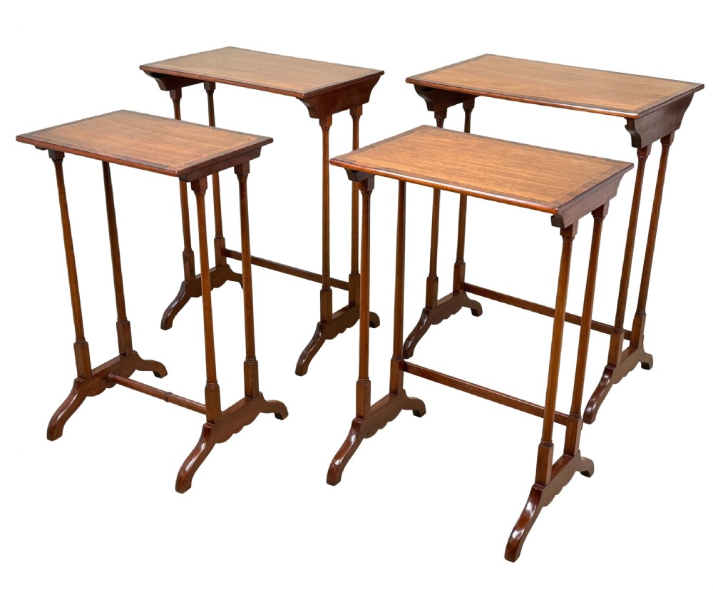 A set of four 19th century mahogany quartetto tables nested together, featuring slender turned legs and trestle feet. View XII