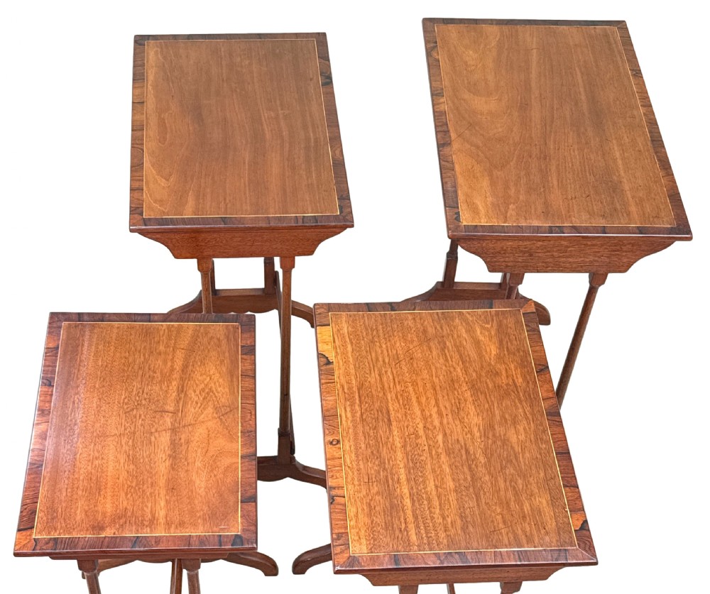 A set of four 19th century mahogany quartetto tables nested together, featuring slender turned legs and trestle feet. View XIII