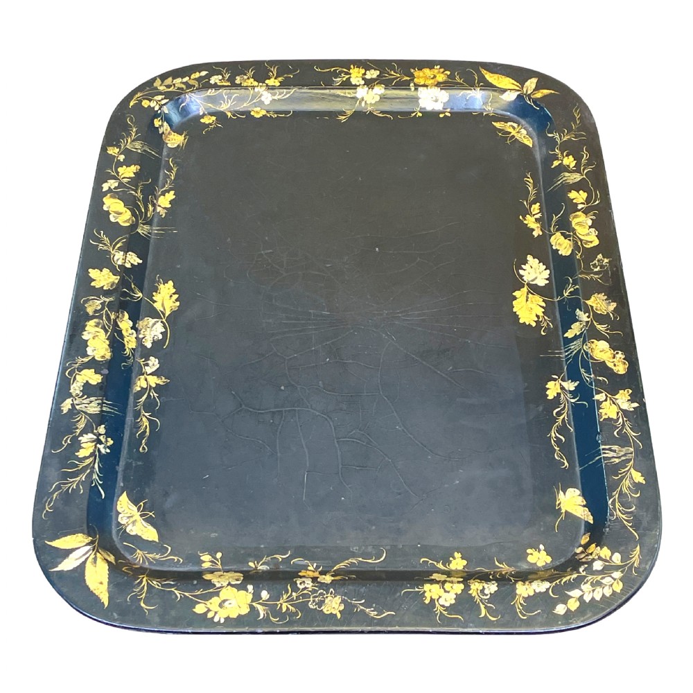 A black lacquered rectangular papier-mache tray table with gilded floral decorations set on ebonised faux bamboo legs. View V